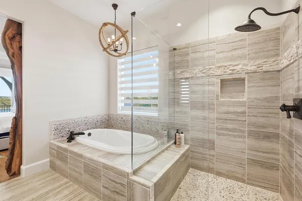 a bathroom with a tub a sink and a shower