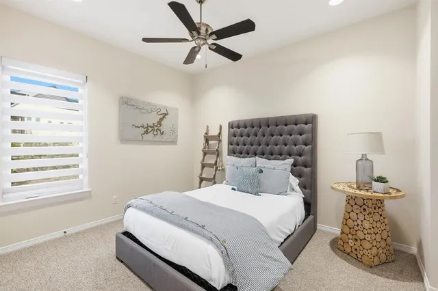 a bedroom with a large bed and a window