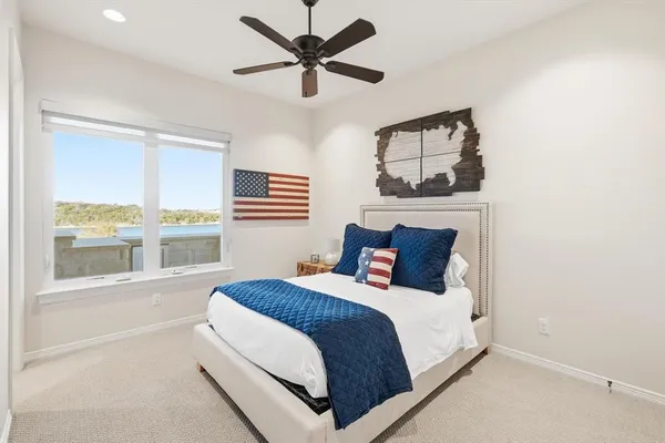 a bedroom with a large bed and a window