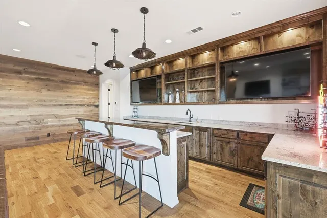 a kitchen with granite countertop a sink and cabinets