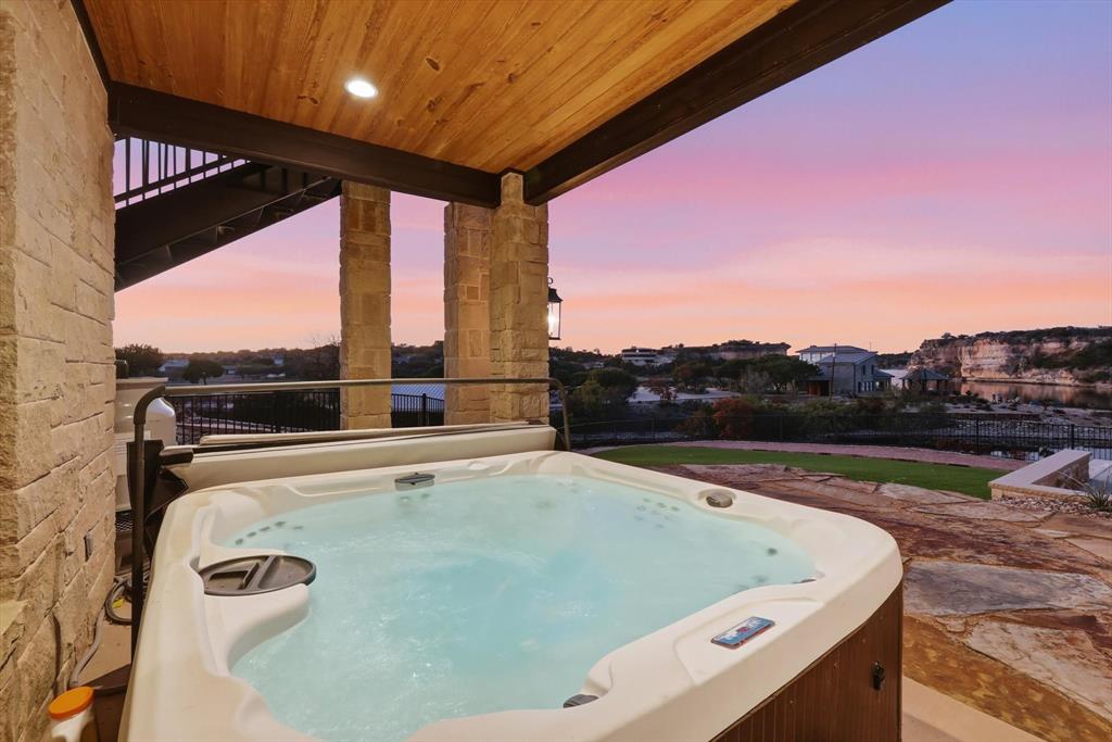 7105 West Hells Gate Drive Strawn, TX 76475 - Photo 34 of 39 a view of roof deck with furniture and city view