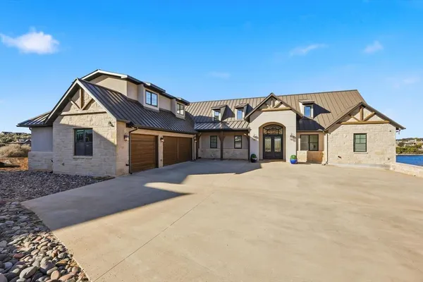 a view of a house with a yard and garage