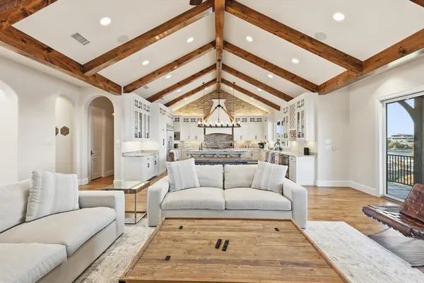 a living room with furniture a rug and white walls