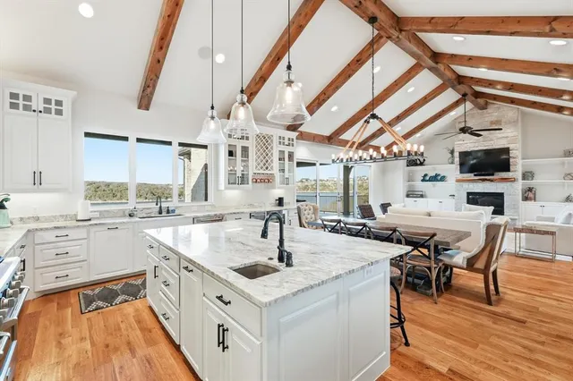a large white kitchen with a large window