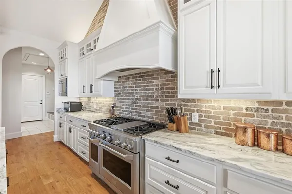 a kitchen with sink stove and cabinets