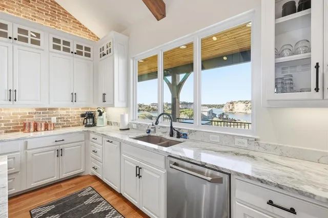 a kitchen with a sink window and cabinets
