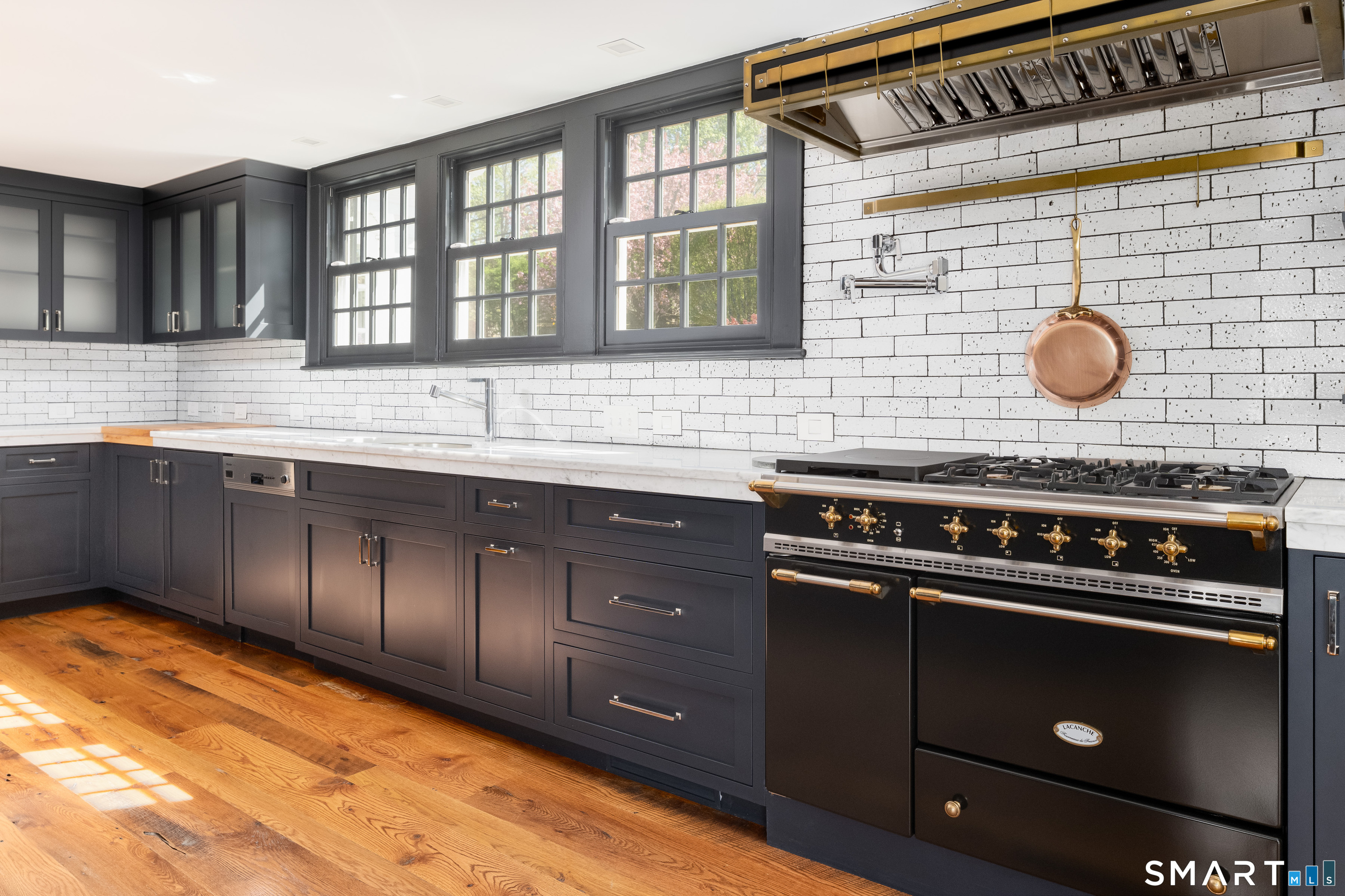 155 Long Ridge Road Danbury, CT 06810 - Photo 18 of 40 Handcrafted Lacanche ranges from Burgundy, together with Sub-Zero refrigeration, reflect the serious quality of the kitchen and the broader standard of the house.