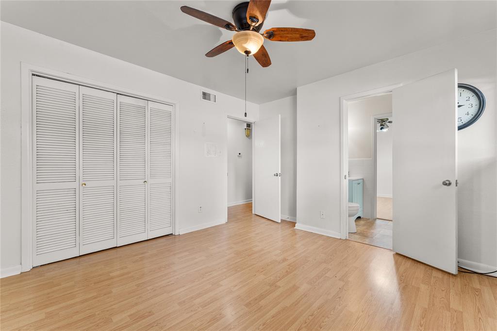 2612 Glendale Drive Waco, TX 76708 - Photo 19 of 38 Unfurnished bedroom featuring light wood-style floors, a closet, a ceiling fan, and ensuite bathroom