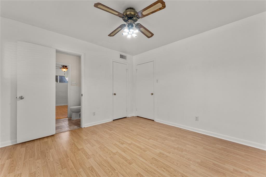 2612 Glendale Drive Waco, TX 76708 - Photo 20 of 38 Unfurnished bedroom with light wood finished floors, ceiling fan, and connected bathroom