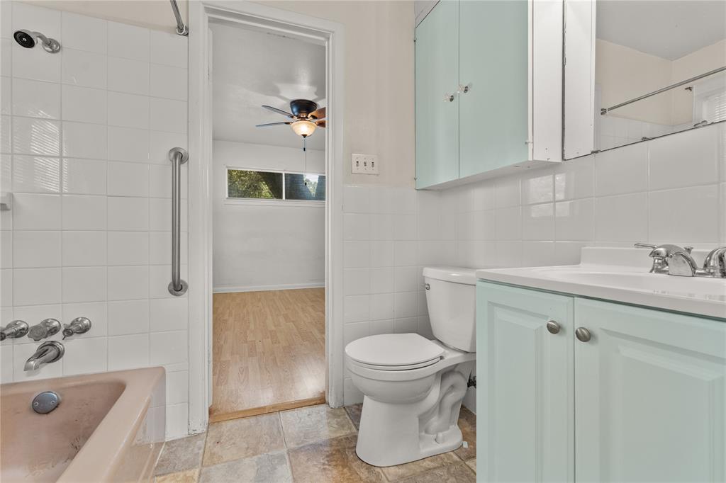 2612 Glendale Drive Waco, TX 76708 - Photo 22 of 38 Full bath featuring tile walls, shower / bathtub combination, vanity, and a ceiling fan