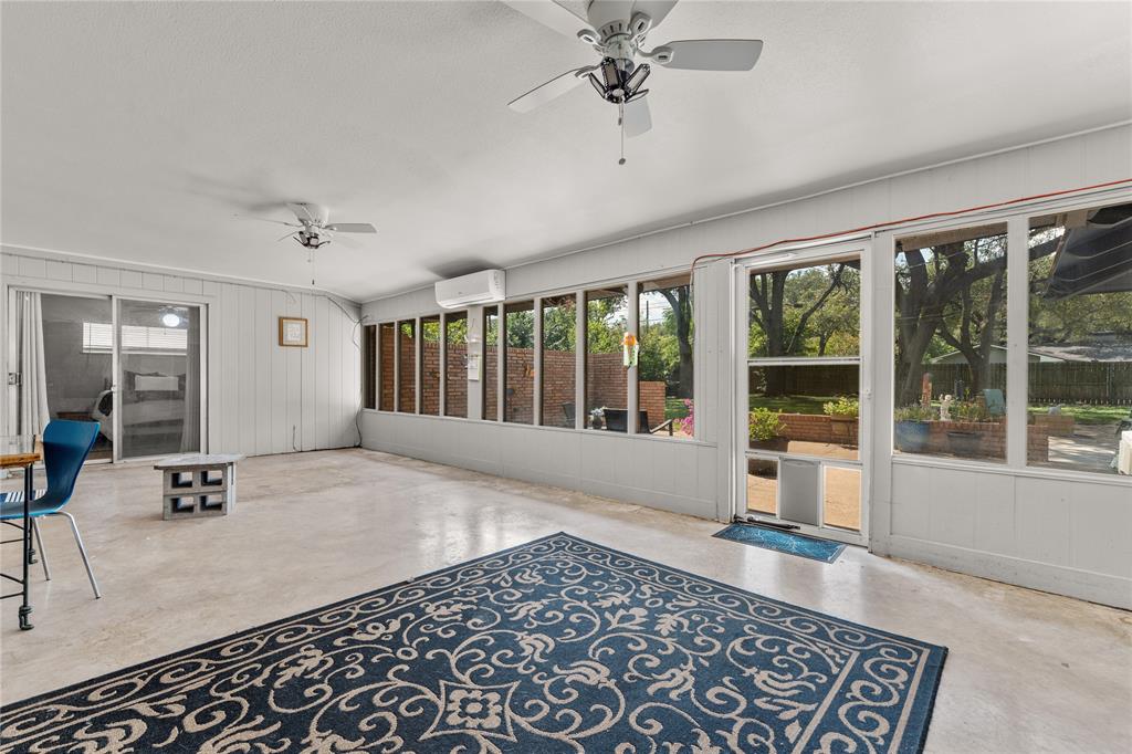 2612 Glendale Drive Waco, TX 76708 - Photo 24 of 38 Unfurnished sunroom with ceiling fan, plenty of natural light, and wooden walls