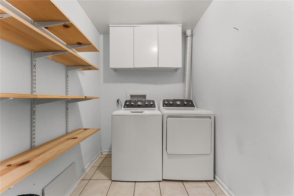 2612 Glendale Drive Waco, TX 76708 - Photo 32 of 38 Laundry room featuring light tile patterned floors, washing machine and dryer, and cabinet space