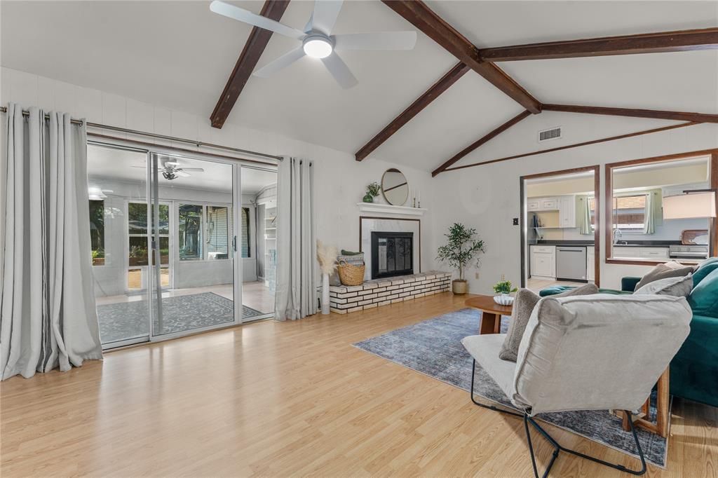 2612 Glendale Drive Waco, TX 76708 - Photo 5 of 38 Living room featuring a fireplace, light wood-style floors, and a ceiling fan