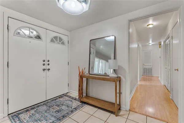 a view of a hallway with entryway wooden floor and front door