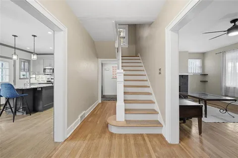 a view of entryway and hall with wooden floor