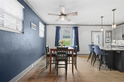 a view of a dining room with furniture and wooden floor