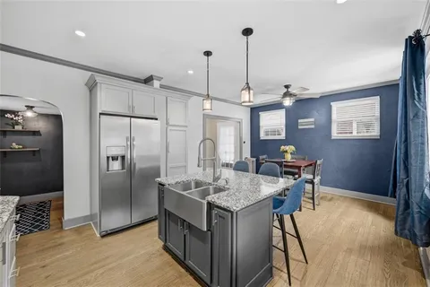 a kitchen with granite countertop a sink a stove and wooden cabinets