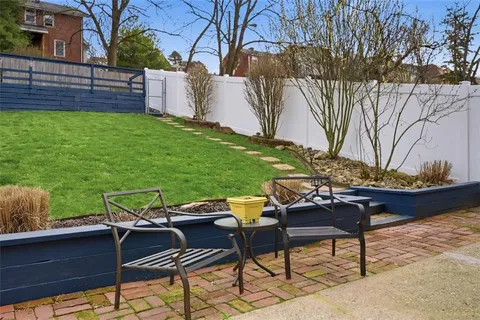 a backyard of a house with table and chairs