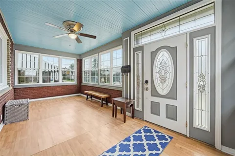 a view of a balcony with furniture and wooden floor
