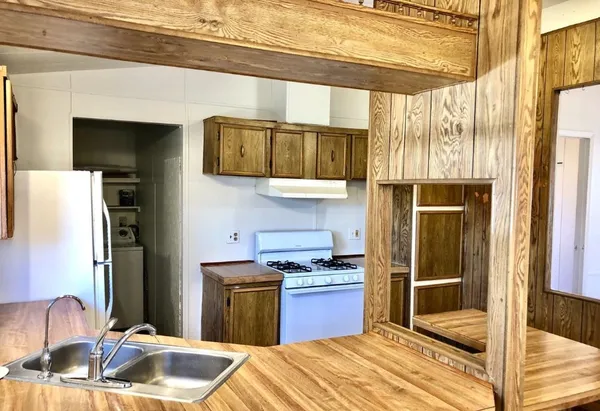 a kitchen with a sink stove and refrigerator