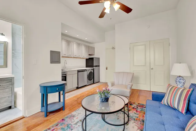 a living room with furniture and a wooden floor