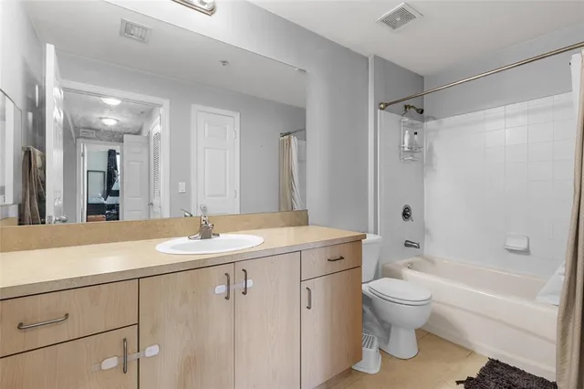 a bathroom with a sink toilet vanity and shower