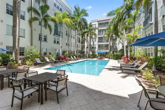 a view of swimming pool with outdoor seating and a patio