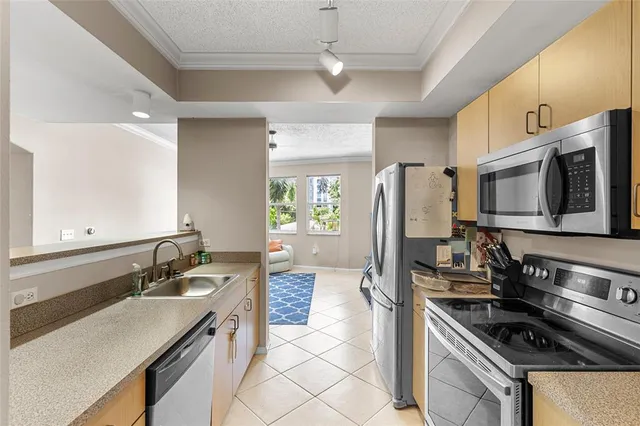 a kitchen with a sink stove top oven and refrigerator