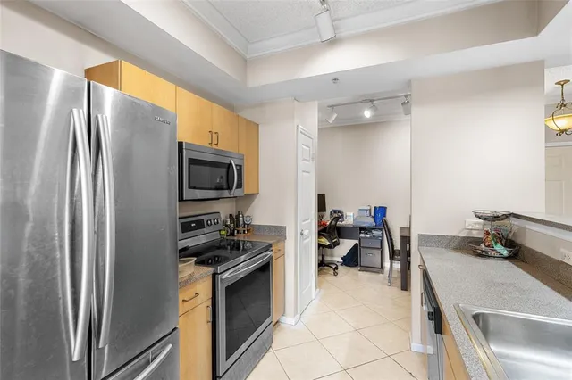 a kitchen with a refrigerator and a sink
