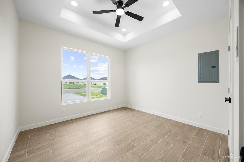 3610 Satelite Street Edinburg, TX 78542 - Photo 12 of 22 wooden floor in an empty room with a window