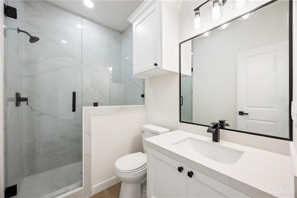 3610 Satelite Street Edinburg, TX 78542 - Photo 13 of 22 a bathroom with a sink toilet a mirror and shower