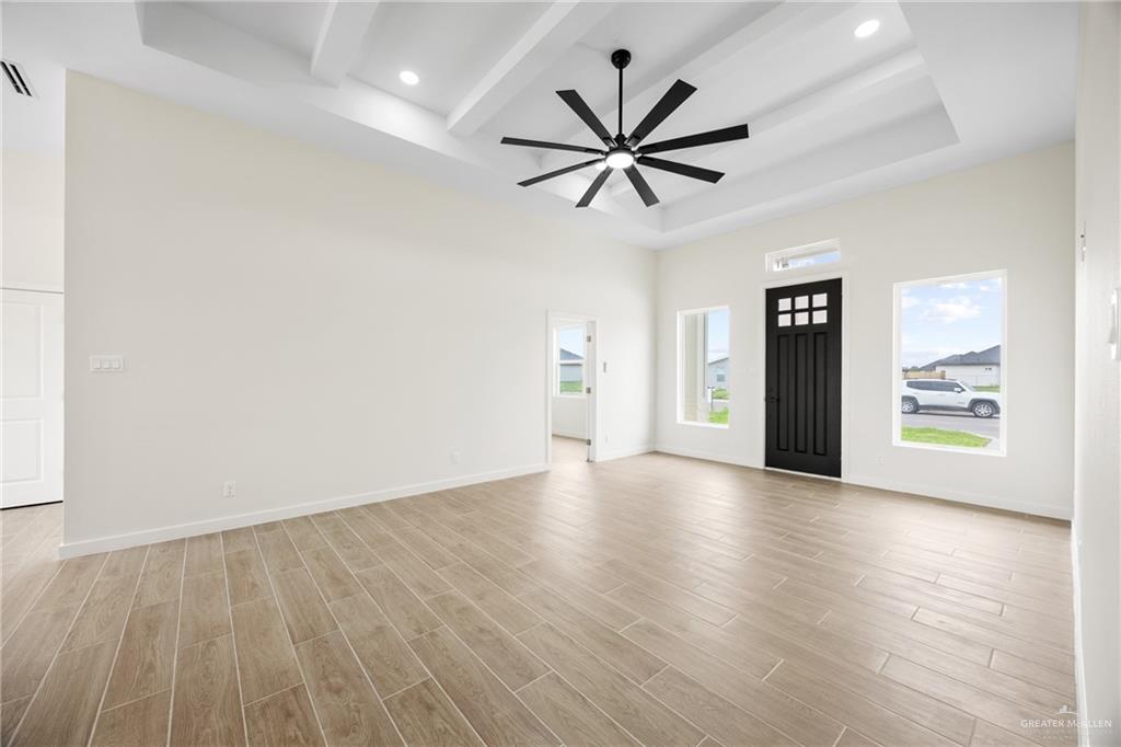 3610 Satelite Street Edinburg, TX 78542 - Photo 2 of 22 an empty room with wooden floor and windows