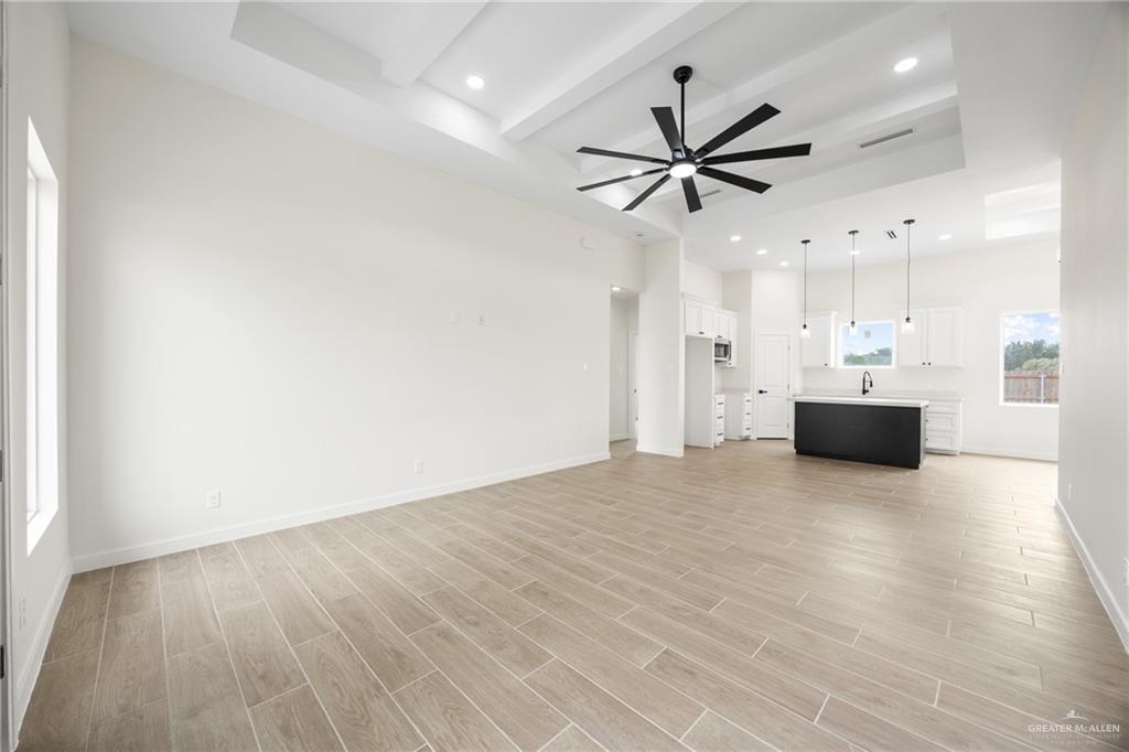 3610 Satelite Street Edinburg, TX 78542 - Photo 3 of 22 a view of a livingroom with a hardwood floor and a ceiling fan