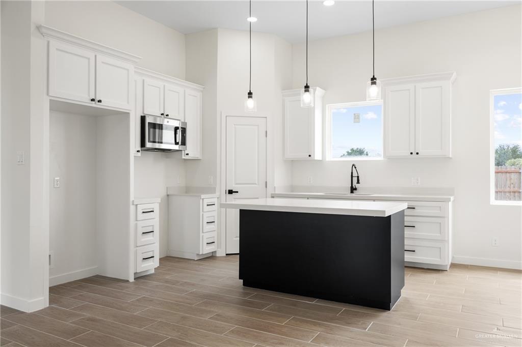 3610 Satelite Street Edinburg, TX 78542 - Photo 4 of 22 a kitchen with stainless steel appliances a sink stove and cabinets