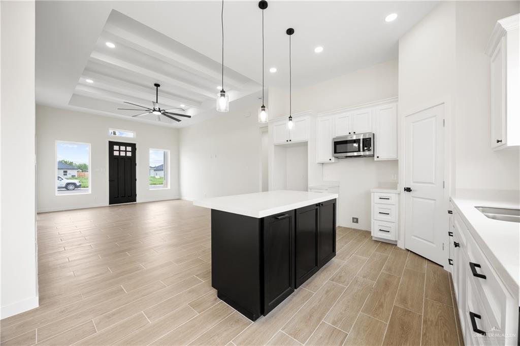 3610 Satelite Street Edinburg, TX 78542 - Photo 6 of 22 a kitchen with stainless steel appliances granite countertop a refrigerator a sink dishwasher and a stove with wooden floor