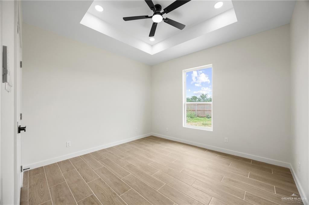 3610 Satelite Street Edinburg, TX 78542 - Photo 9 of 22 wooden floor in an empty room with a window
