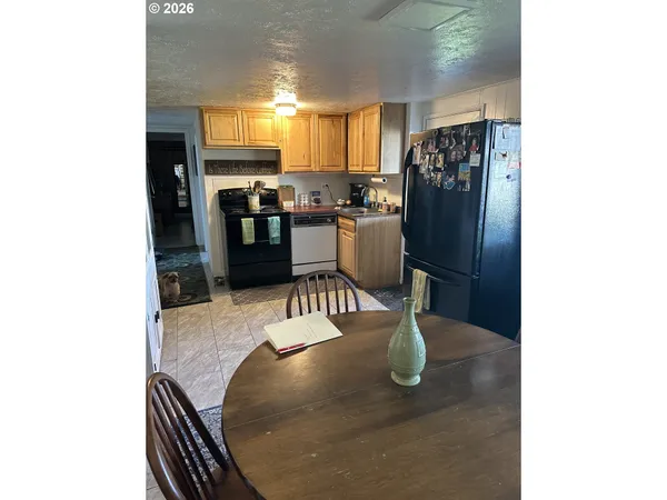 a kitchen with a table and chairs