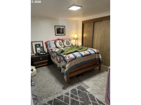 a bedroom with a bed and table