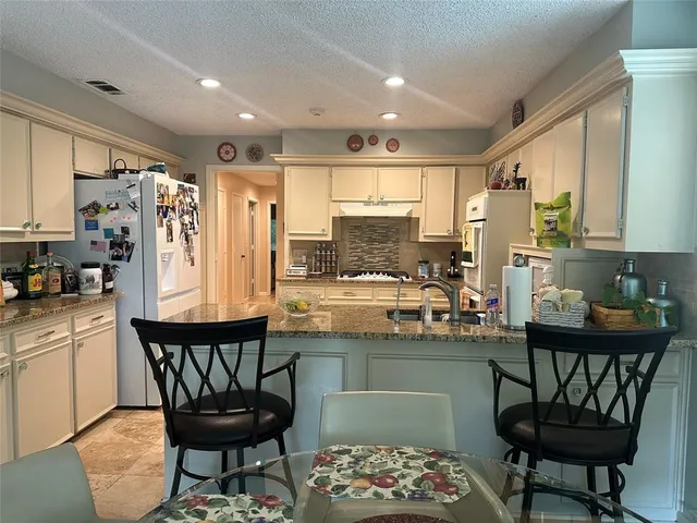 a view of outdoor dining space with a patio and plants