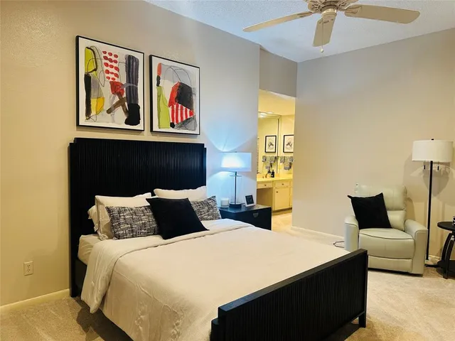 a bedroom with a bed and a painting on the wall