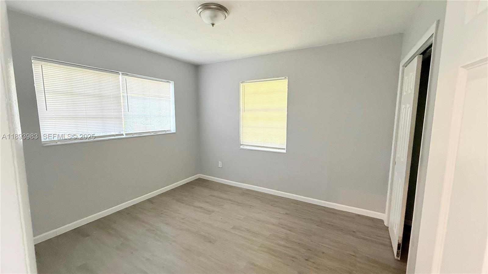 337 Northeast 57th Street, Unit 2 Miami, FL 33137 - Photo 5 of 9 an empty room with a window