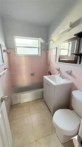 a bathroom with a sink mirror toilet and bathtub