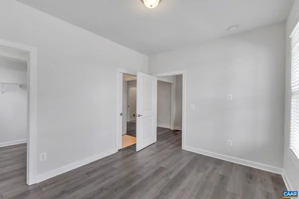 a view of an empty room with wooden floor