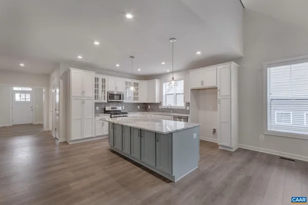a kitchen with stainless steel appliances granite countertop a stove and a refrigerator