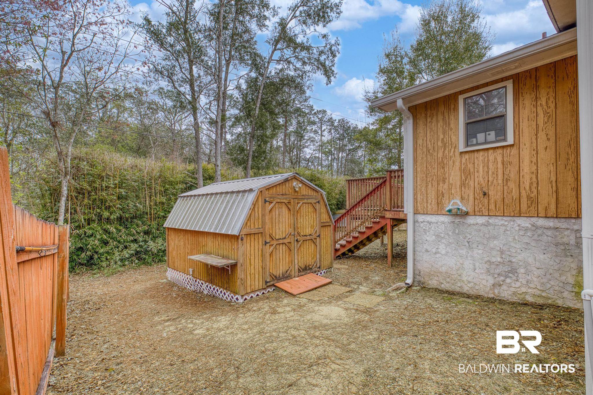 1437 Rio Circle Lillian, AL 36549 - Photo 25 of 46 View of patio featuring a storage shed and stairs