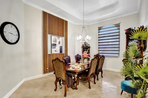 a view of a dining room with furniture and chandelier