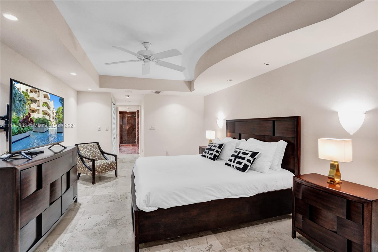 101 Crandon Boulevard, Unit 175 Key Biscayne, FL 33149 - Photo 8 of 23 a bedroom with a bed and a flat tv screen on dresser