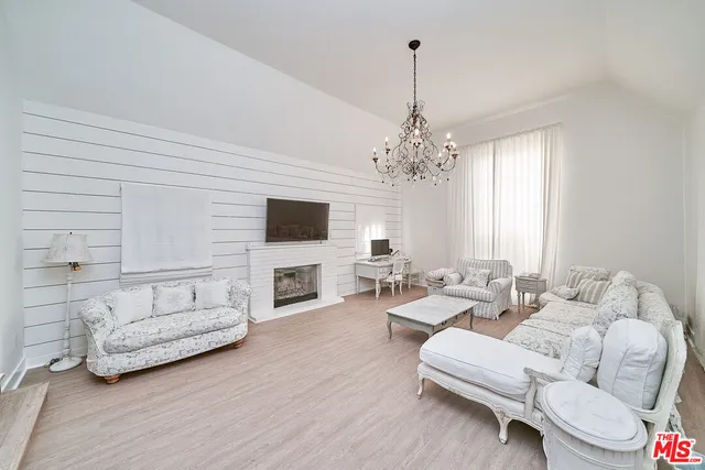 a living room with furniture flat screen tv and fireplace