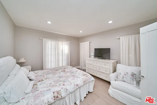 a bedroom with a bed and a television