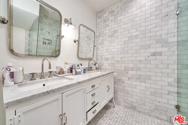 a bathroom with a double vanity sink mirror and